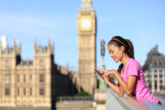 Runner looking down at the Thames from Westminster Bridge with the Houses of Parliament in the background on a running tour
